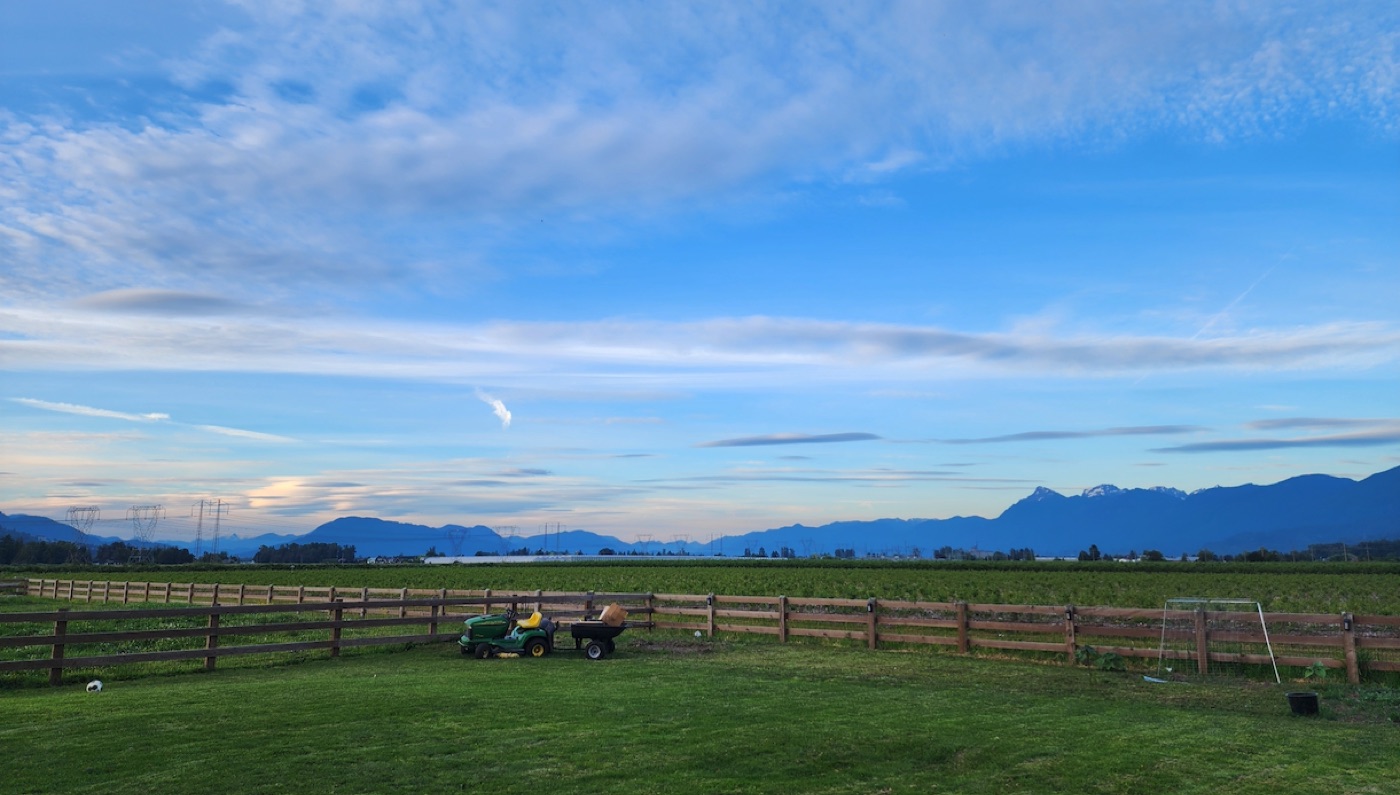 Sasquatch Landscaping lawn-maintenance equipment against the Fraser Valley mountain range